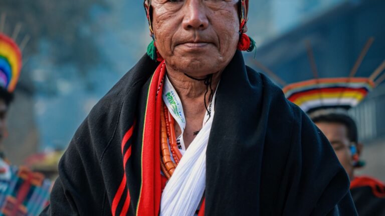 Naga elder in traditional shawl and attire at a cultural gathering